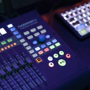 A mixing console with a keyboard and a mouse that is perfect for creating jingles.