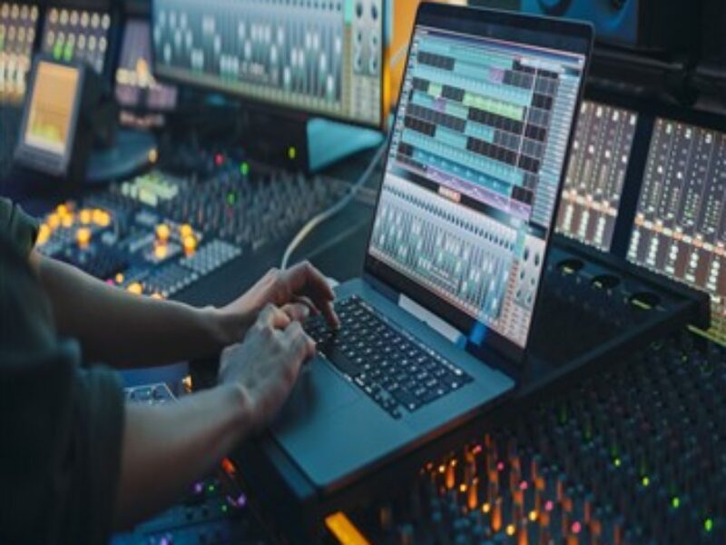 A musician enhancing skills using a laptop in Orb Music Studio.