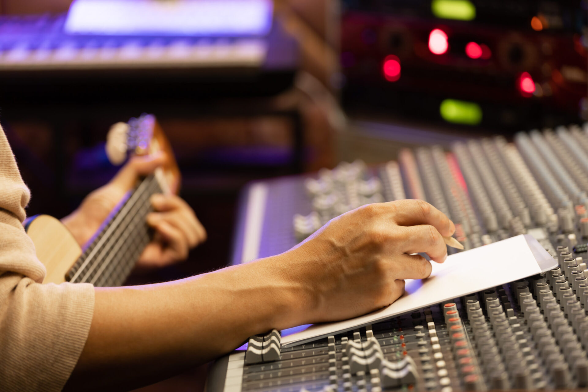 A person jotting down prices and packages in a recording studio.