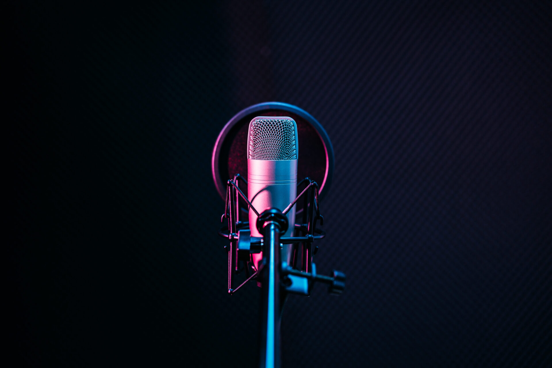 A microphone with prices and packages displayed in front of a dark background.