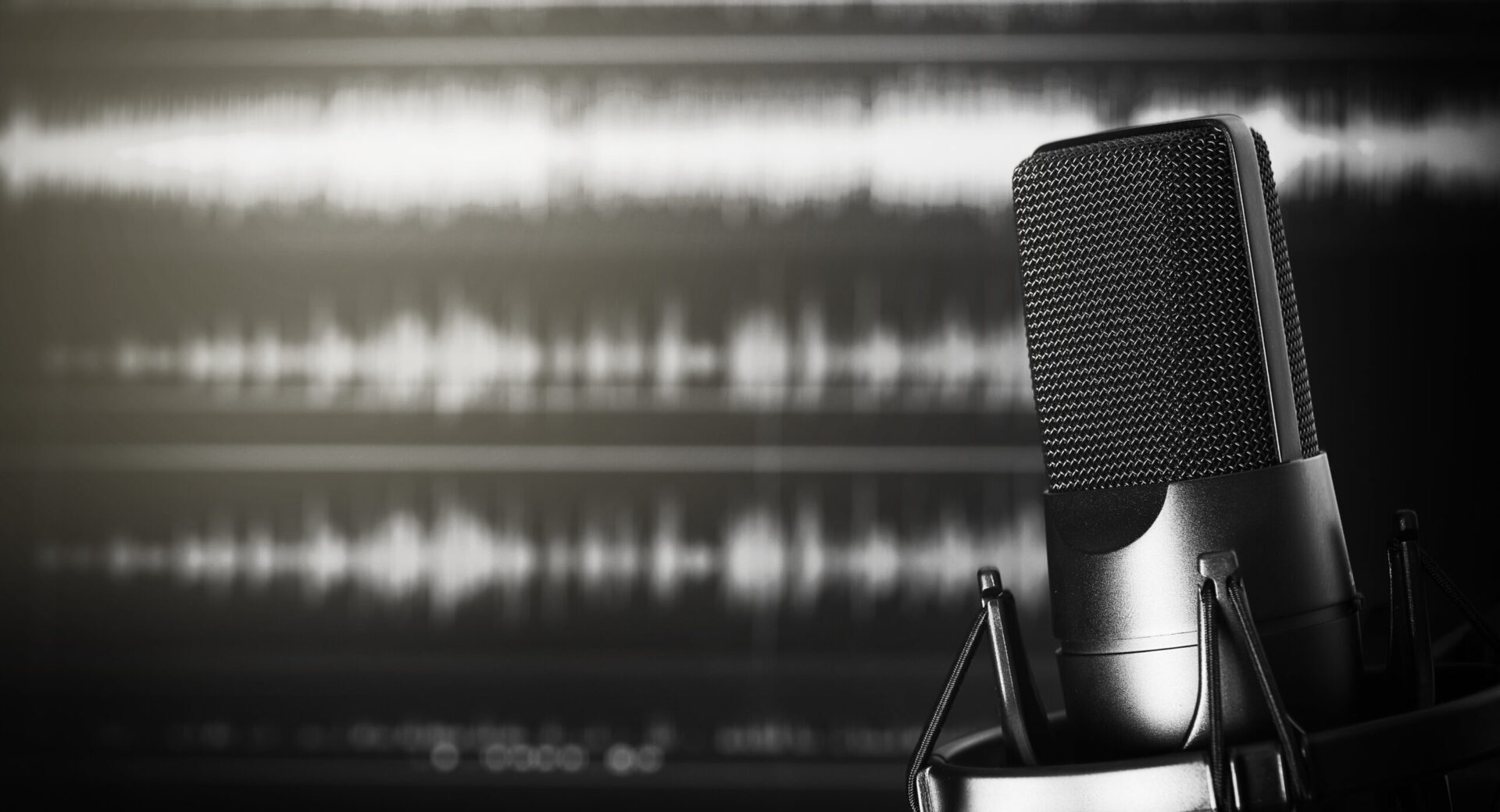 A microphone capturing a demo recording with a sound wave background.